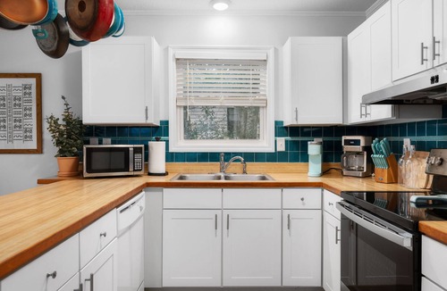 Colington Harbour House | Boho-chic Banks getaway with luxe interior, hot tub, AC, & W/D - dog friendly