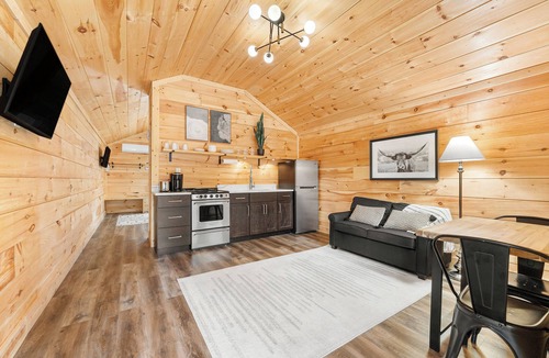 Hartwell RV Rental | Cabin #2: One king-size bed with a full kitchen for cooking and a large gravel parking pad beside the cabin for easy boat trailer storage.