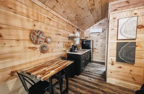Hartwell RV Rental | Cabin #4: Two queen-size beds with a kitchenette and a large gravel parking pad beside the cabin for easy boat or trailer storage.