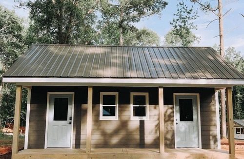 Hartwell RV Rental | Cabin #4: Two queen-size beds with a kitchenette and a large gravel parking pad beside the cabin for easy boat or trailer storage.
