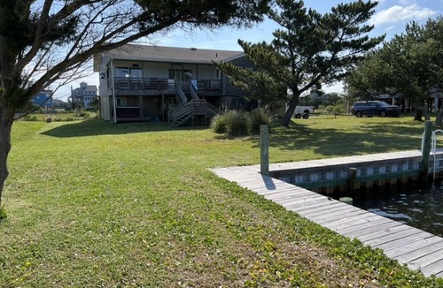 Frisco House | Canal Front Home with a Dock and Hot Tub minutes from the beach!