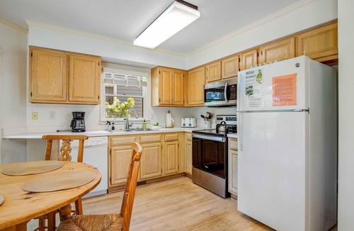 Pelican Bay House | Casual cottage w/screened porch & shared pool - walk to the beach