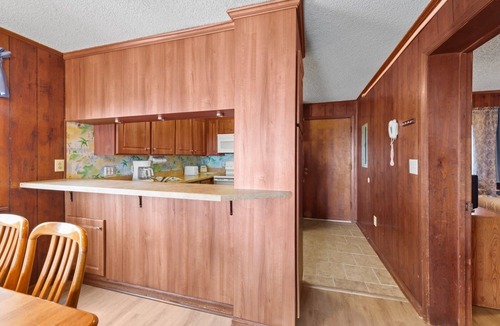 Crescent Beach Condo | Cozy oceanfront condo, rustic wood paneling and fully equipped kitchen | Sun Villas - A-2