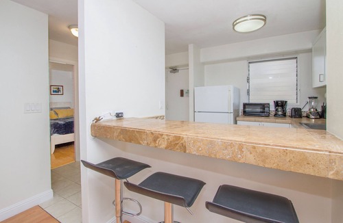 McCully - Moiliili Apartment | Cozy two bedroom, sleeps 6. Wifi, full kitchen, balcony, and pool.
