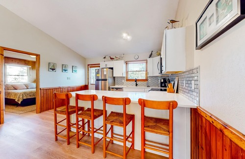 Sea Scape House | Dog-friendly coastal home with balcony, open layout, wood finishes, & AC