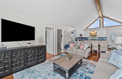 Colington Harbour House | Dog-friendly home with canal views, dock, kayaks, sunroom, deck, & firepit