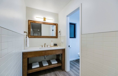 San Angelo Hotel | Elegant Suite with Separate Living Room & Mini Fridge – Ideal for Relaxation and