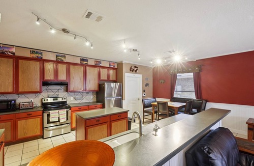Hutto House | Huge Handicap Accessible Home Sleeps 21. Game Room, Office, Stocked Kitchen with so many TVs