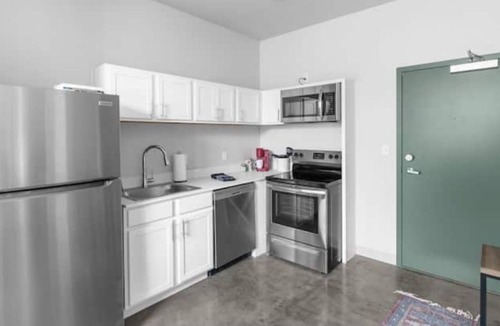 Central City Apartment | Modern loft with rooftop deck, fitness center, and private parking.