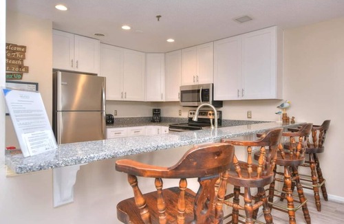 Long Beach Condo | Oceanfront comfort at SSV 108-Finz Up in Oak Island, perfect for family getaways!