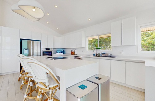 Makaha House | Oceanfront home with wrap around lanai, private sauna, beach access & WIFI