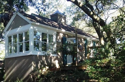 Folly Beach Cottage | Romantic, cozy cottage nestled amongst live oaks & palms, a block from beach.