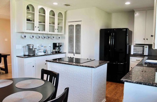 Myra House | Spacious 4BR ranch for up to 13 on 5 private acres near Saint Jo wineries. Features firepit, chef’s kitchen, wine lounge, Smart TV, and pet-friendly options—perfect for family trips and wine weekends.