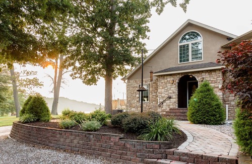 Earlville Villa | Stunning waterfront villa with indoor pool and kids swing set and play area.