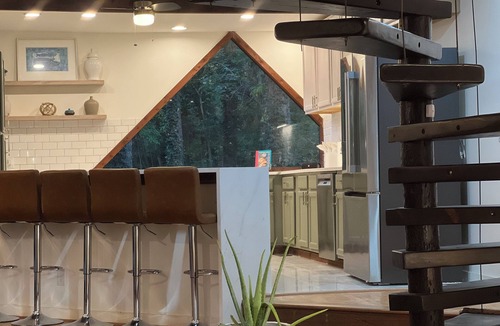 Marietta House | Wood-beam ceilings, large glass windows & a stunning spiral staircase suspended