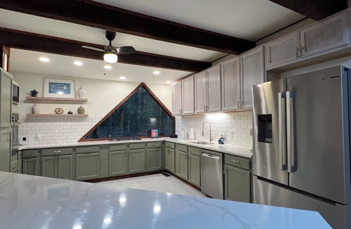 Marietta House | Wood-beam ceilings, large glass windows & a stunning spiral staircase suspended