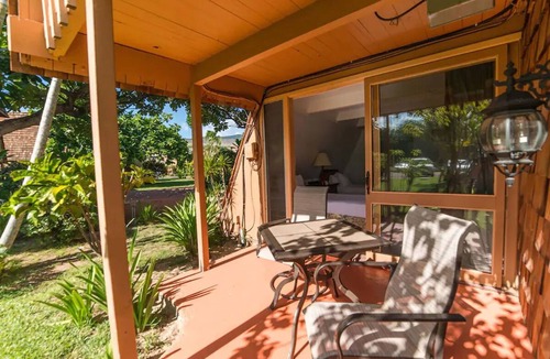 Kaunakakai House | Your Ultimate Oceanfront Retreat | Relaxing Room with Lush Garden View