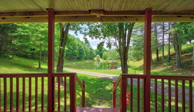 Cozy lakeside cabin with peaceful views, a covered porch, fire pit, and private rural getaway.