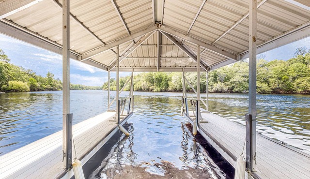 Dog-friendly riverfront home with screened porch, firepit, & private dock
