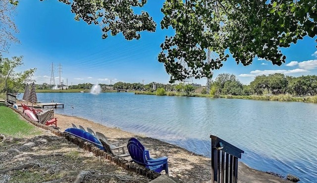 Dog-friendly water view condo with inviting porch, AC, W/D, & modern charm