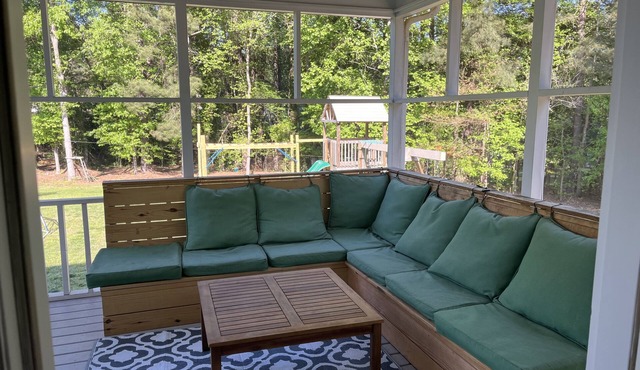 Family friendly home on over an acre with fire pit, screen porch, and more!