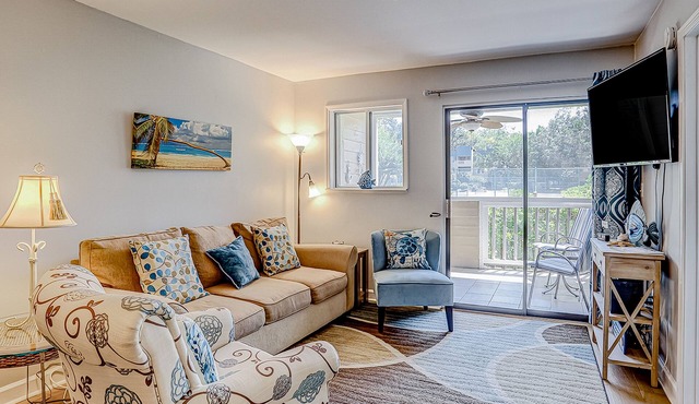 Ground-floor condo with AC, patio, pools, tennis, & beach access