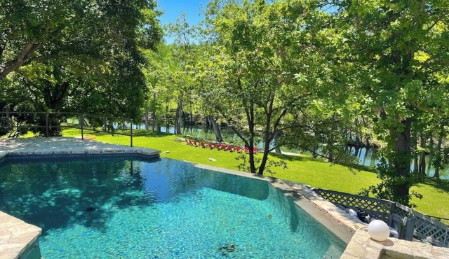 Inviting waterfront home with pool, patio, fireplace, W/D, & dog-friendly