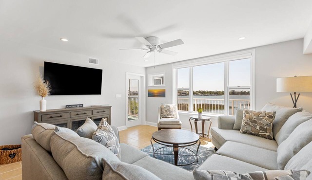 Riverfront condo, Screen porch - Short walk across bridge to beach, shops, and restaurants!