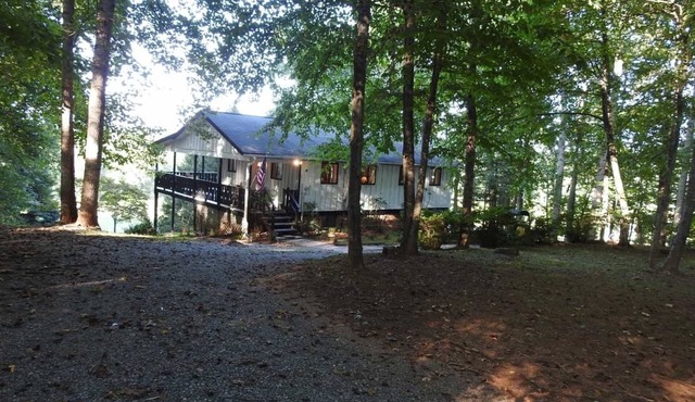Serene and secluded mountain side retreat home next to The French Broad River.