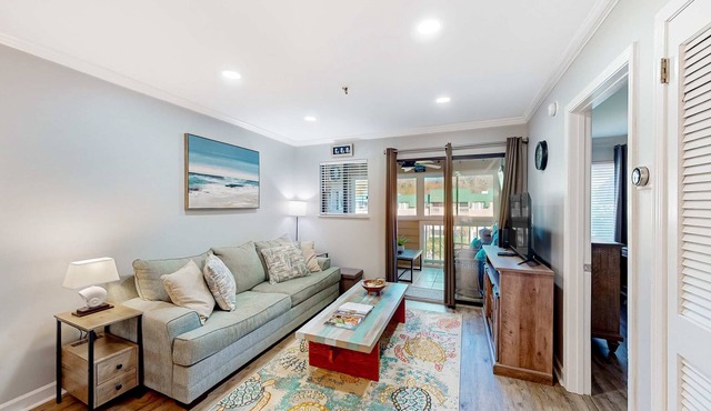Waterfront villa with resort amenities, beach access, open layout, AC, & WD